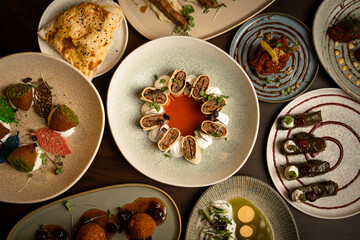 Middle Eastern or Arabic cuisine with a variety of mezze on a rustic concrete backdrop Food that is Halal. Cuisine from Lebanon, Turkey, and Egypt, with mixed veggies and a gorgeous table top view