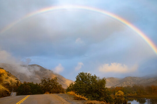 Rainbow Over River After Storm