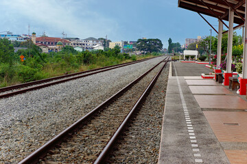 Fototapeta premium Countryside train station and long railway tracks