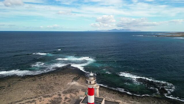 El Cotillo Lighthouse, Fuerteventura, Canary Islands, Spain. The island of Lanzarote is visible in the distance. High-quality drone footage. 