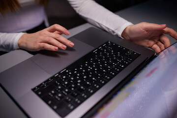 Close-up shot of female hands typing on laptop. Woman fingers tapping on computer keyboard. Work...