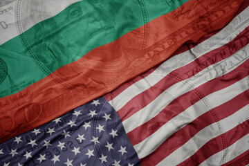 Obraz premium waving colorful flag of united states of america and national flag of bulgaria on the dollar money background. finance concept.