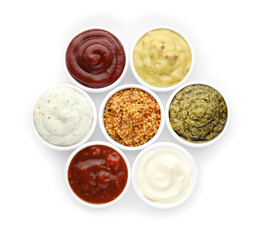 Many different sauces in bowls on white background, top view