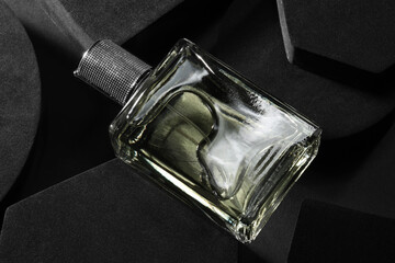 Stylish presentation of luxury men`s perfume in bottle on black background