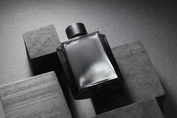Stylish presentation of luxury men`s perfume in bottle on black background, above view