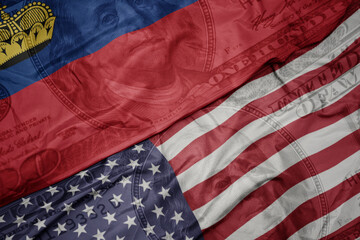 Obraz premium waving colorful flag of united states of america and national flag of liechtenstein on the dollar money background. finance concept. macro
