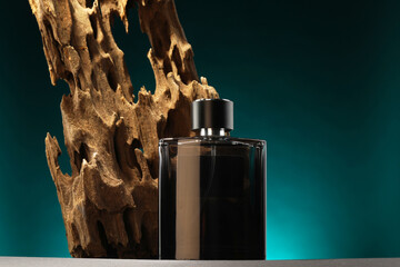 Luxury men`s perfume in bottle on grey table against color background