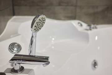 White metal whirlpool bath without water in apartment bathroom.