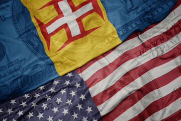 Obraz premium waving colorful flag of united states of america and national flag of madeira on the dollar money background. finance concept. macro