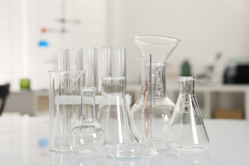 Laboratory analysis. Different glassware on white table indoors