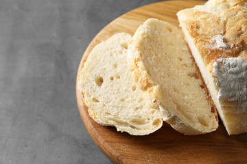Freshly baked cut sourdough bread on grey table, closeup. Space for text