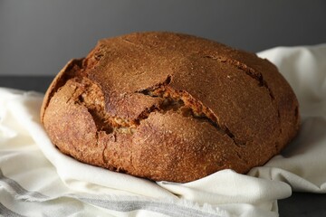 Freshly baked sourdough bread on table against grey background, closeup
