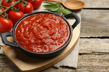 Homemade tomato sauce in bowl on wooden table, closeup