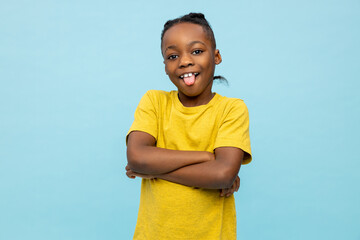 Boy in yellow tshirt standing on blue background and gesticulating