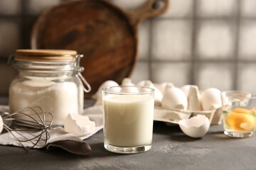Different ingredients for dough on grey table, closeup