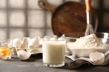 Different ingredients for dough on grey table, closeup