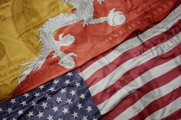 Fototapeta premium waving colorful flag of united states of america and national flag of bhutan on the dollar money background. finance concept.