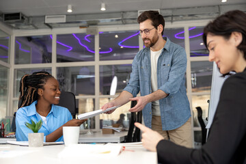 Multiracial coworkers cooperating working at office meeting