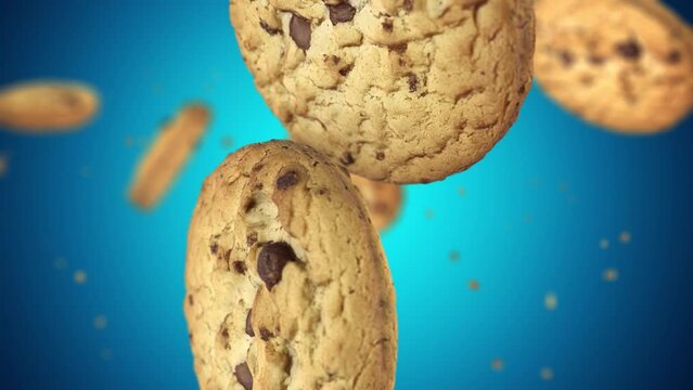 Close up of chocolate Chip cookies falling down in slow motion, Blue background.