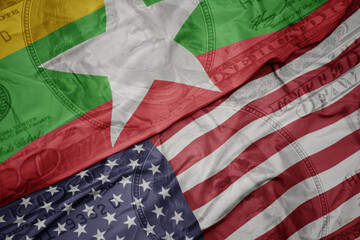 waving colorful flag of united states of america and national flag of myanmar on the dollar money...