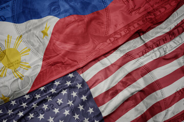 waving colorful flag of united states of america and national flag of philippines on the dollar money background. finance concept.