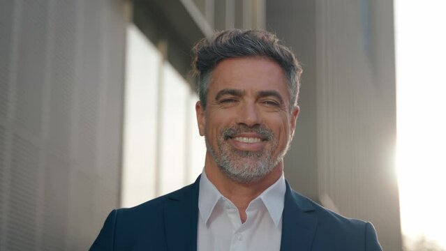 Handsome hispanic senior business man smile at camera. Headshot close up portrait of indian or latin confident mature good looking middle age leader, ceo male businessman in suit on office background.