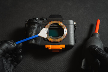 Professional sensor cleaning on a mirrorless camera, close-up photo.