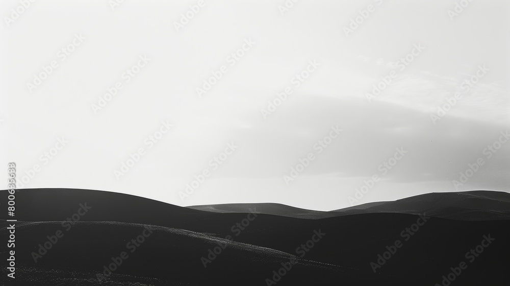 Poster a minimalist black and white photograph capturing the shadowy outlines of a distant mountain range a