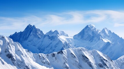 Panoramic view of snow-capped mountains under blue sky