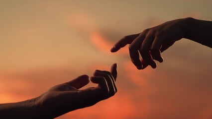 Finger Touching hands, silhouette of Hands in sky, couple feels love. Gentle touch with fingers of...