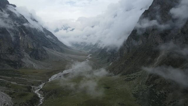 Aerial drone footage of a drone flying in the clouds in a valley of uttarakhand
