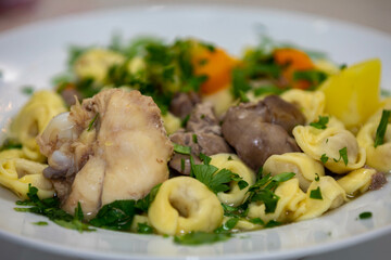Traditional capeletti soup with chicken and vegetables. Typical winter dinner soup