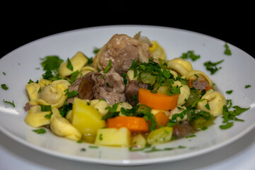 Traditional capeletti soup with chicken and vegetables. Typical winter dinner soup