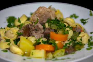 Traditional capeletti soup with chicken and vegetables. Typical winter dinner soup