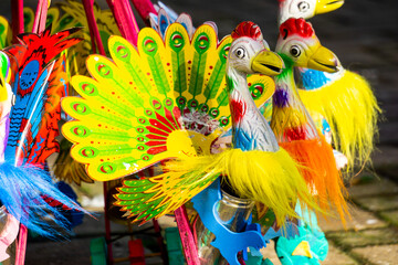 Colorful traditional wooden toy in the shape of a peacock