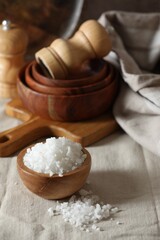 Organic salt in wooden bowl on table