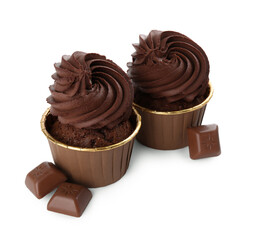Delicious cupcakes and chocolate pieces isolated on white