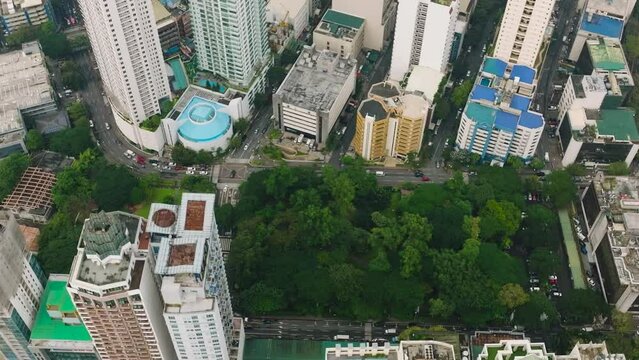 Top view of modern office buildings and cars running on streets. Makati, Metro Manila. Philippines.