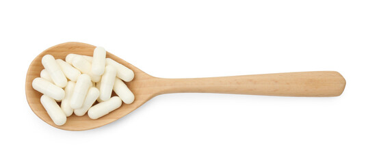 Vitamin capsules in wooden spoon isolated on white, top view. Health supplement
