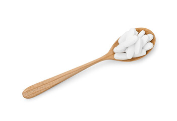 Vitamin pills in wooden spoon isolated on white, top view. Health supplement