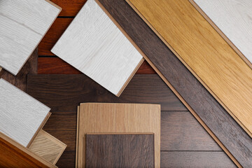 Different samples of wooden flooring as background, flat lay