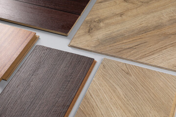 Different samples of wooden flooring on white background