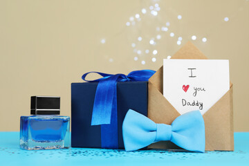 Happy Father's Day. Card with phrase I Love You, Daddy in envelope, bow tie, perfume and gift box...