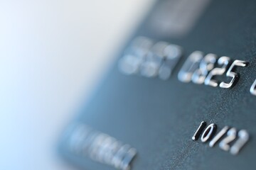 One credit card on light background, macro view