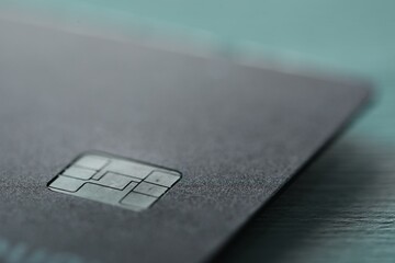 One credit card on color background, macro view
