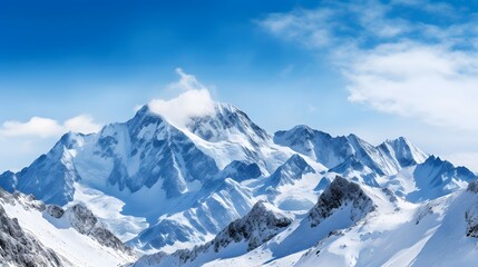 Fototapeta na wymiar Panoramic view of snow-capped mountains under blue sky