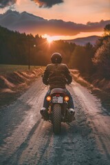 A man riding a motorcycle on a dusty dirt road. Suitable for outdoor adventure concept