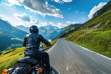 A man riding a motorcycle down a scenic mountain road. Perfect for adventure and travel concepts