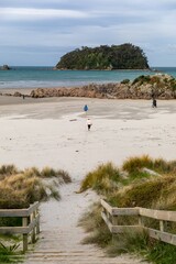 Children running on sandy beach ain Mount Maunganui, Bay Of Plenty, New Zealand
