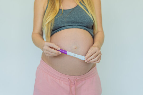 Joyful pregnant woman shares the exciting news, proudly displaying her positive pregnancy test and a heartwarming ultrasound photo